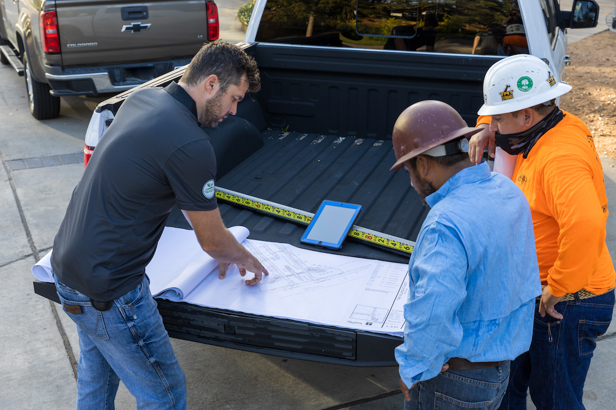 Landscape contractors checking the project blueprint